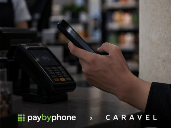 a hand using a phone to pay at a cash register