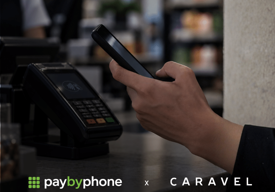 a hand using a phone to pay at a cash register
